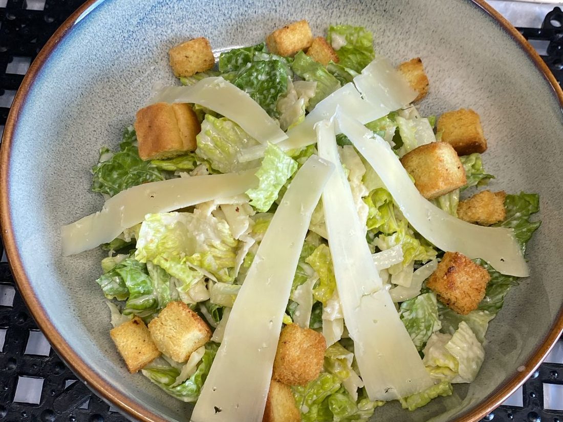 Classic Caesar salad with shaved parmesan and croutons