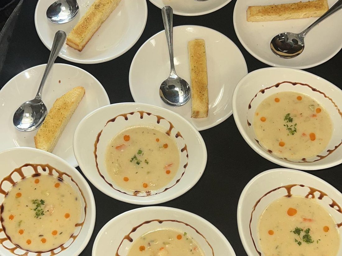 Bowls of hearty conch chowder with toasted bread