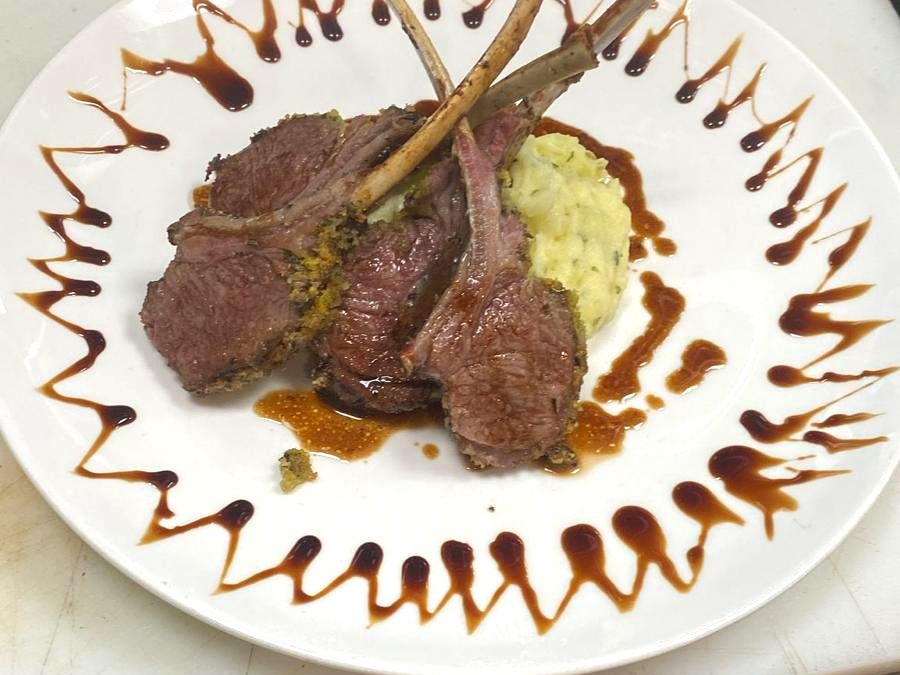 Herb crusted rack of lamb with mashed potatoes and jus